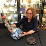 Image of Susan Lahey appraising a vase