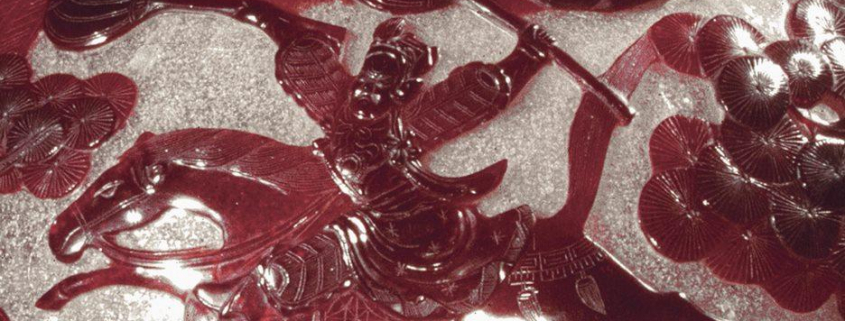 Close up of a warrior vase (Red and White painted Chinese glass)